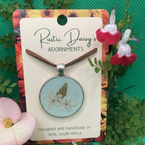 medium-large-round-silver-coloured-pendant-with-pale-blue-background-and-white-wild-flowers-with-fern-leaf