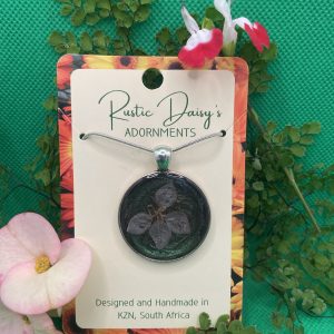 Medium large silver coloured pendant with metallic Chameleon dust background and white Agora flower