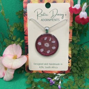 medium-large-round-silver-coloured-pendant-with-red-background-and-white-baby-breath-flowers