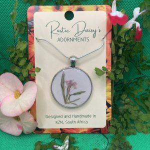 medium-large-round-silver-coloured-pendant-with-white-background-and-pink-flower-with-leaves