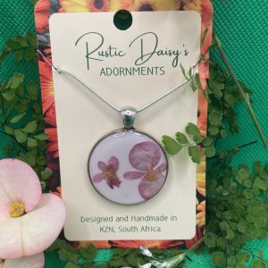 medium-large-round-silver-coloured-pendant-with-white-background-and-pink-begonia-flowers