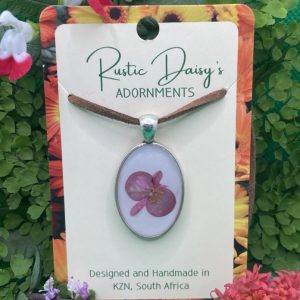 medium-silver-coloured-oval-shaped-pendant-with-white-background-and-pink-begonia-flower