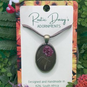 medium-oval-bronze-coloured-pendant-with-bronze-background-and-red-and-white-flower-with-leaves