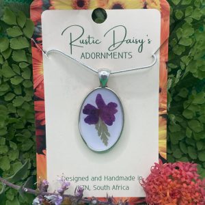 medium-oval-silver-coloured-pendant-with-white-background-and-violet-flower-with-leaf