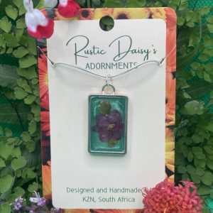 medium-rectangular-silver-coloured-pendant-with-metallic-green-background-and-pink-begonia-flower
