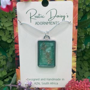 medium-rectangular-silver-coloured-pendant-with-metallic-green-background-sprig-of-wild-flowers
